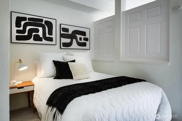 a bedroom with a bed and wall painting