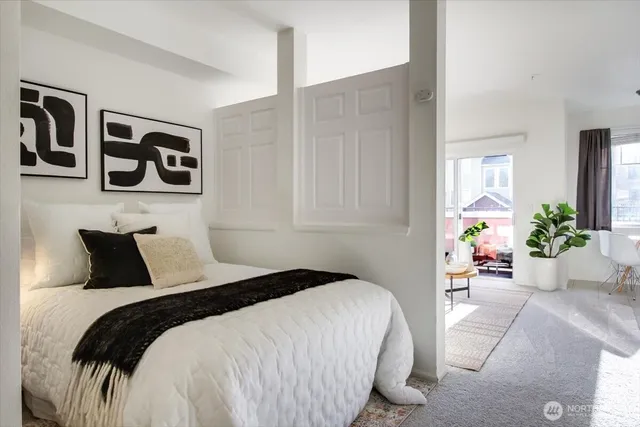 a bedroom with a bed and potted plant