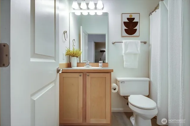 a bathroom with a toilet sink and mirror