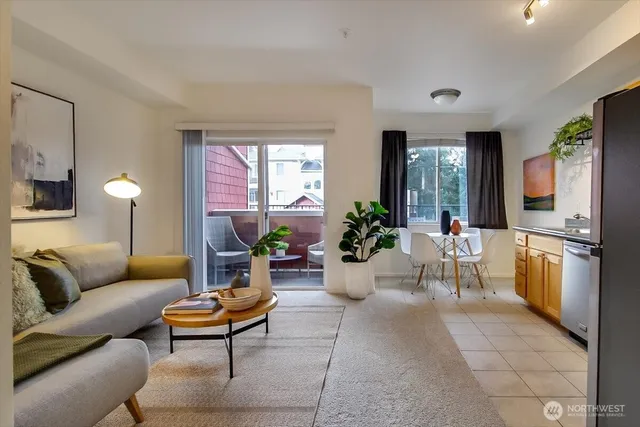 a living room with furniture potted plant and a window