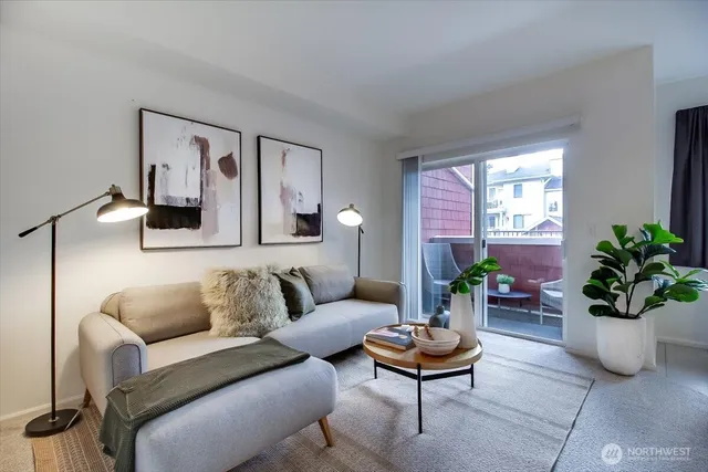 a living room with furniture potted plant and window