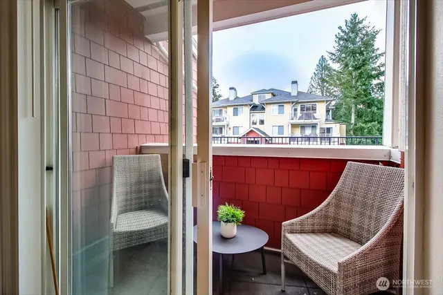 a balcony with table and chairs