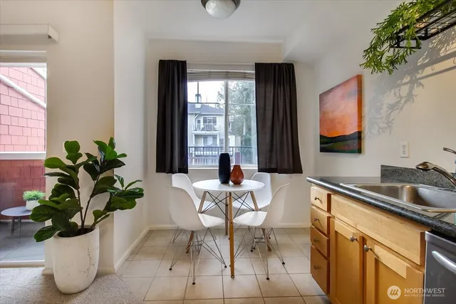 a dining room with furniture and potted plant