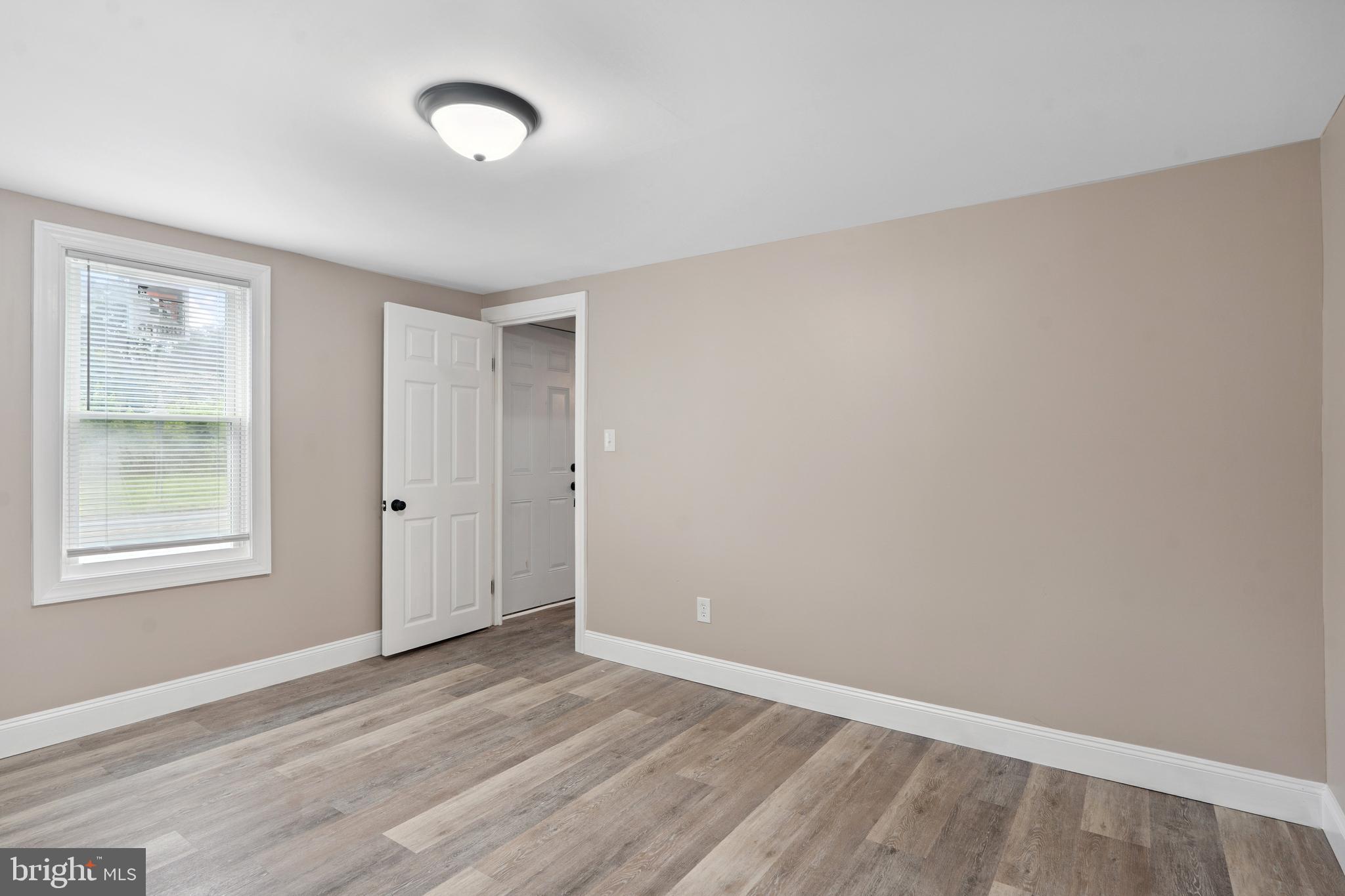 918 East Commerce Street Bridgeton, NJ 08302 - Photo 17 of 30 wooden floor in an empty room with a window