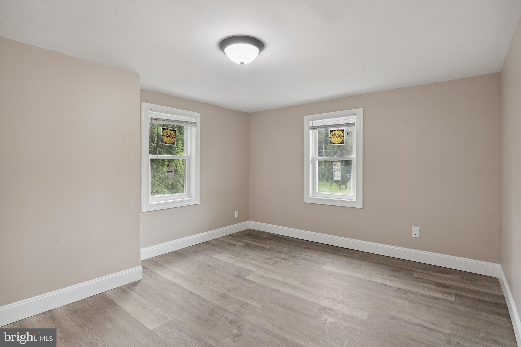 918 East Commerce Street Bridgeton, NJ 08302 - Photo 22 of 30 a view of an empty room with wooden floor and a window