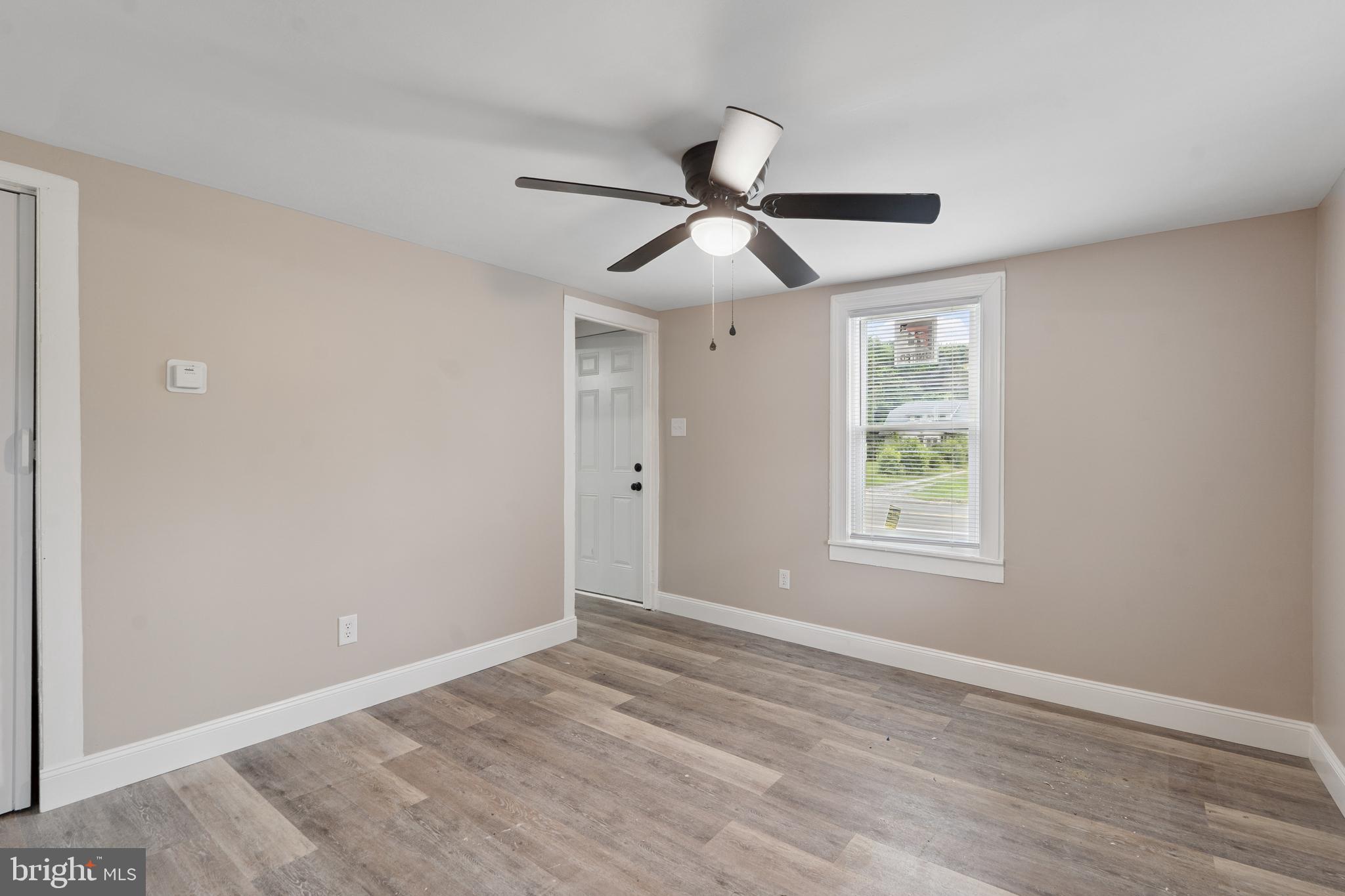918 East Commerce Street Bridgeton, NJ 08302 - Photo 6 of 30 a view of empty room with wooden floor and fan