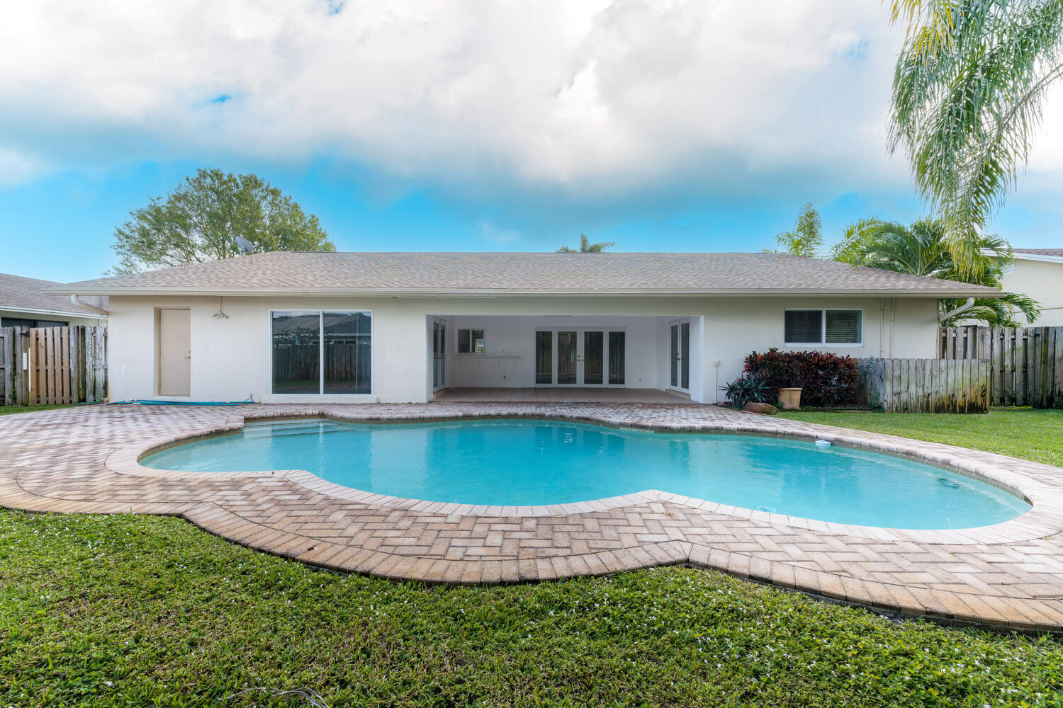 4695 Brandywine Drive Boca Raton, FL 33487 - Photo 1 of 28 a front view of a house with swimming pool having outdoor seating