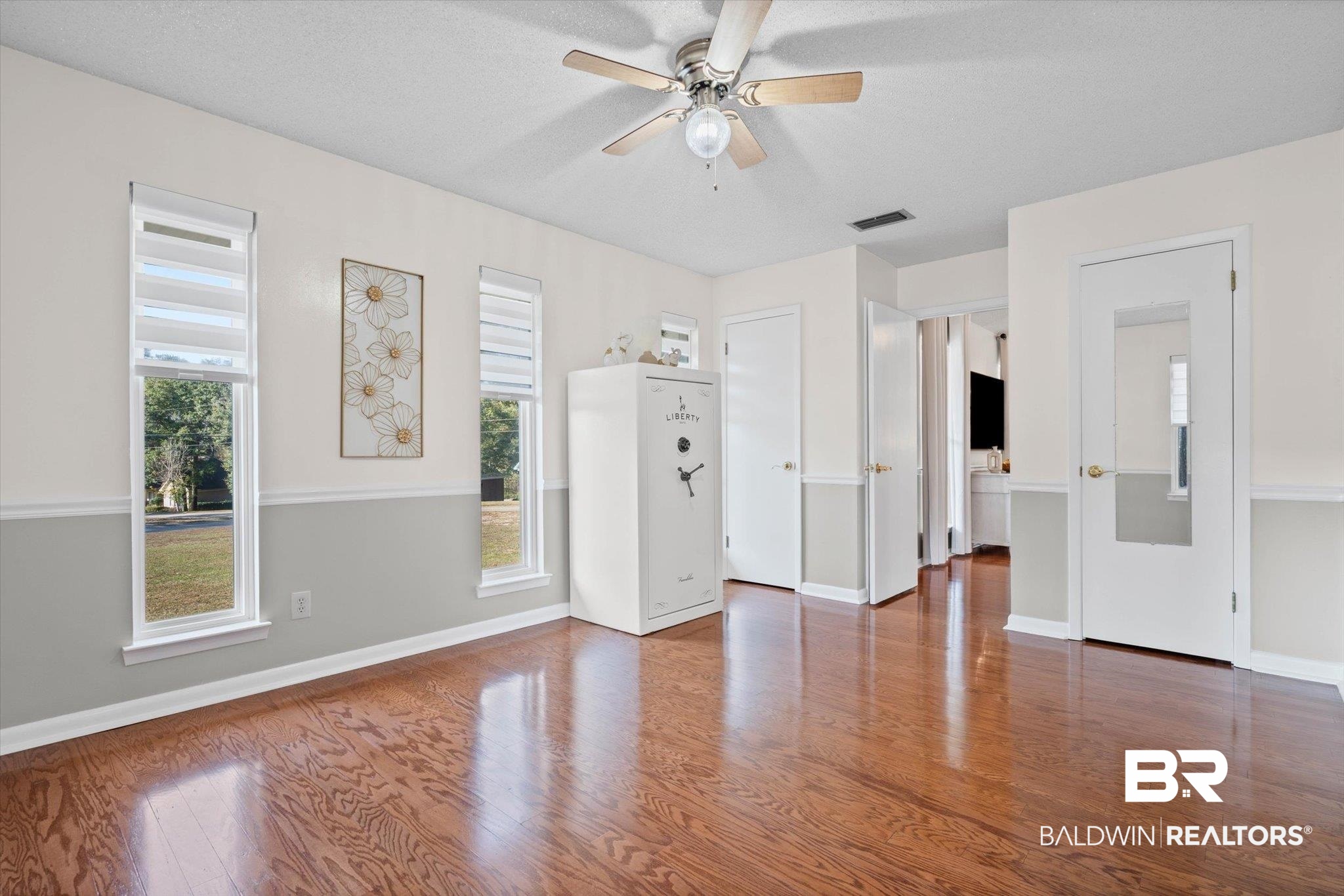 4567 Pine Avenue Saraland, AL 36571 - Photo 20 of 48 Unfurnished living room with wood finished floors, ceiling fan, and a textured ceiling