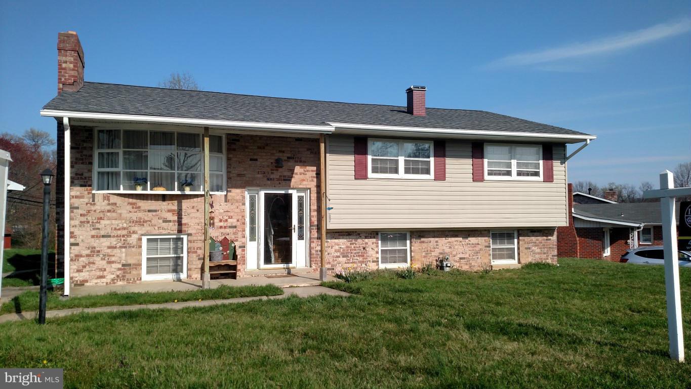 6304 Magdolena Road Baltimore, MD 21237 - Photo 1 of 26 a front view of a house with a yard