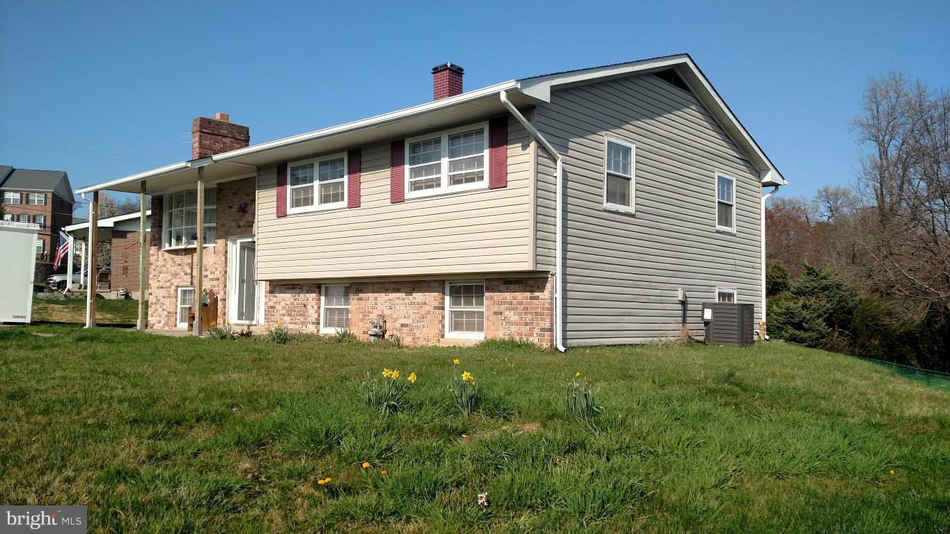 6304 Magdolena Road Baltimore, MD 21237 - Photo 2 of 26 a front view of a house with a yard