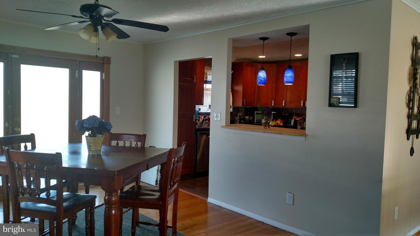 6304 Magdolena Road Baltimore, MD 21237 - Photo 11 of 26 a view of a dining room with furniture and chandelier