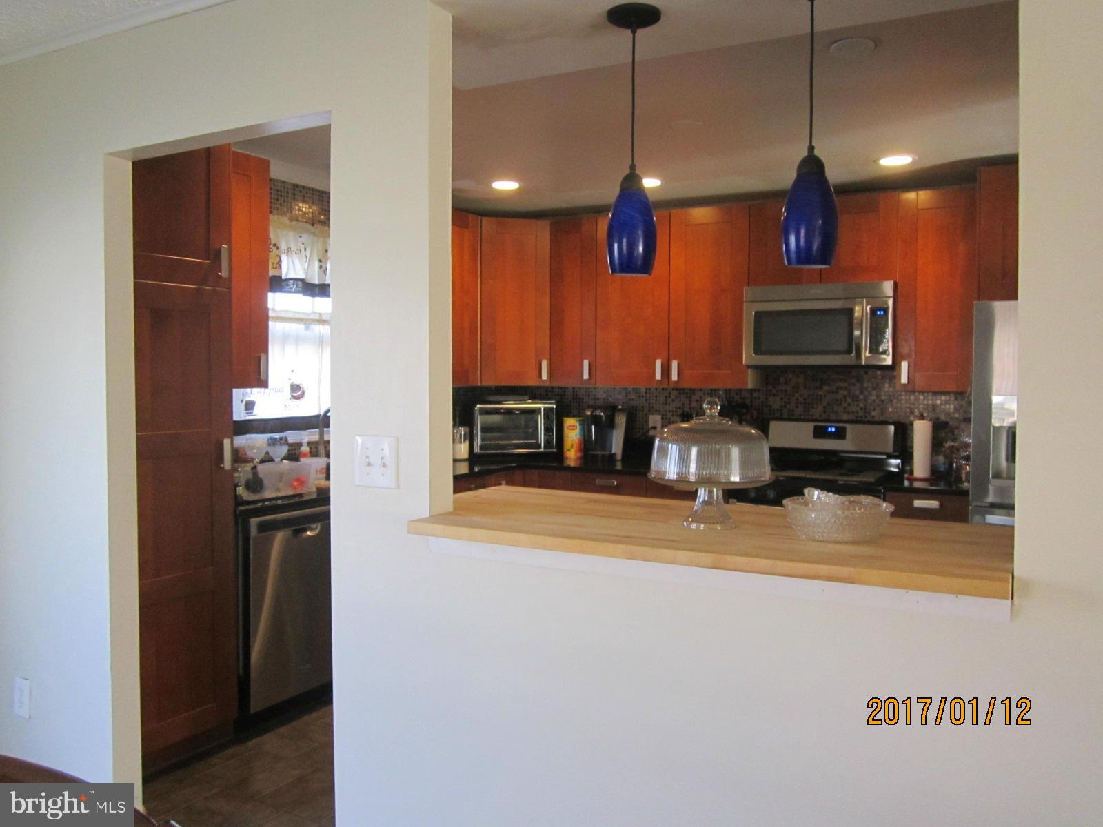6304 Magdolena Road Baltimore, MD 21237 - Photo 12 of 26 a view of a room with kitchen a sink and a refrigerator