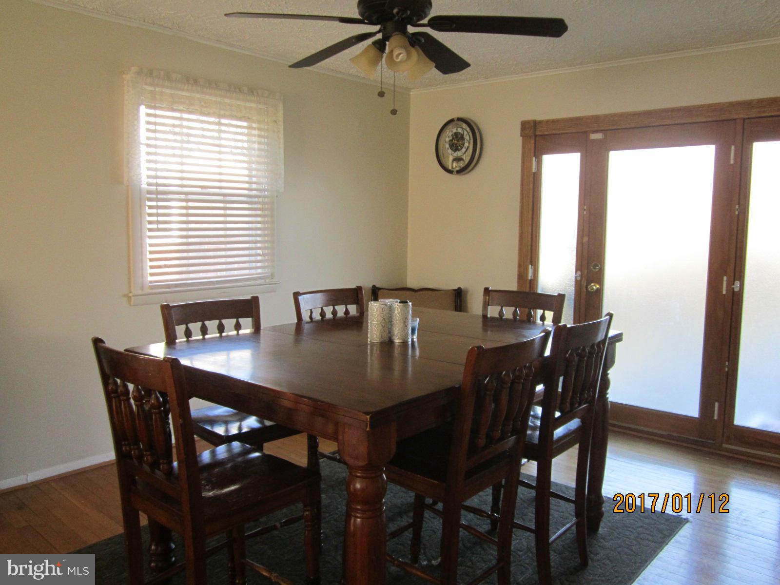 6304 Magdolena Road Baltimore, MD 21237 - Photo 13 of 26 a view of a dining table and chairs in a room
