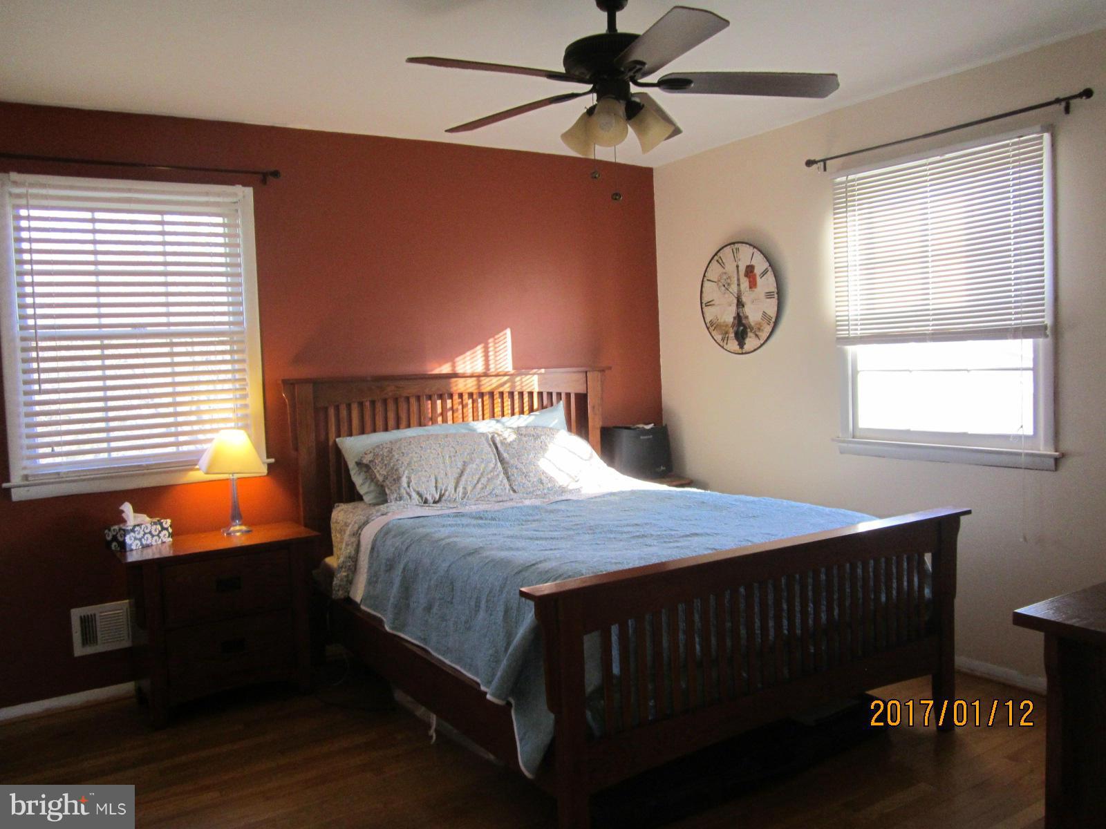 6304 Magdolena Road Baltimore, MD 21237 - Photo 14 of 26 a bedroom with a bed and a window