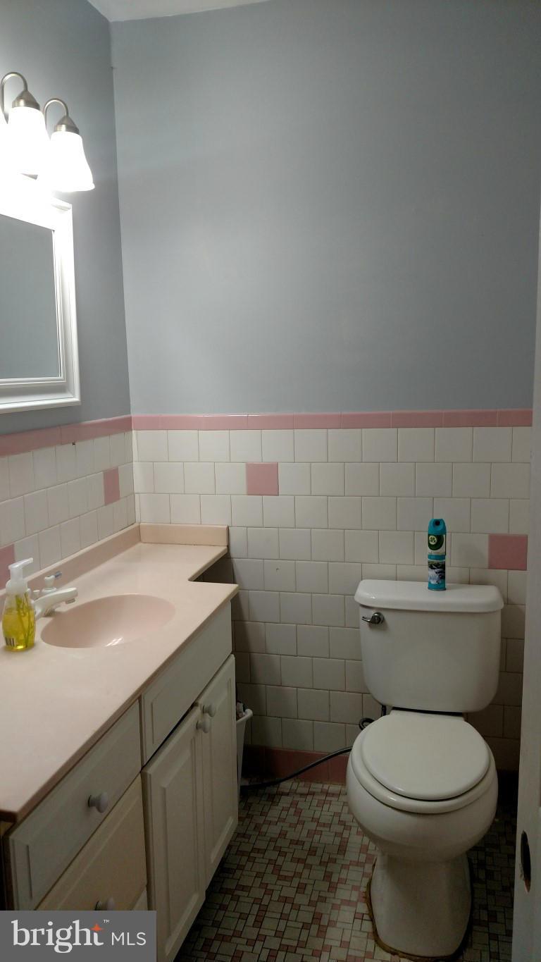 6304 Magdolena Road Baltimore, MD 21237 - Photo 16 of 26 a bathroom with a sink toilet and vanity