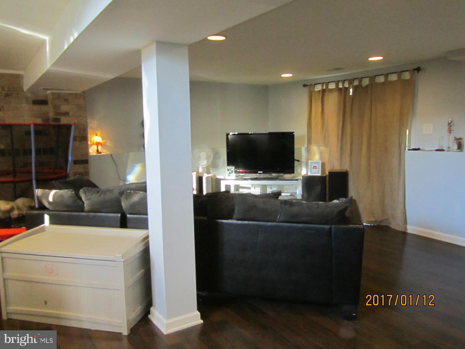 6304 Magdolena Road Baltimore, MD 21237 - Photo 20 of 26 a living room with furniture and a flat screen tv