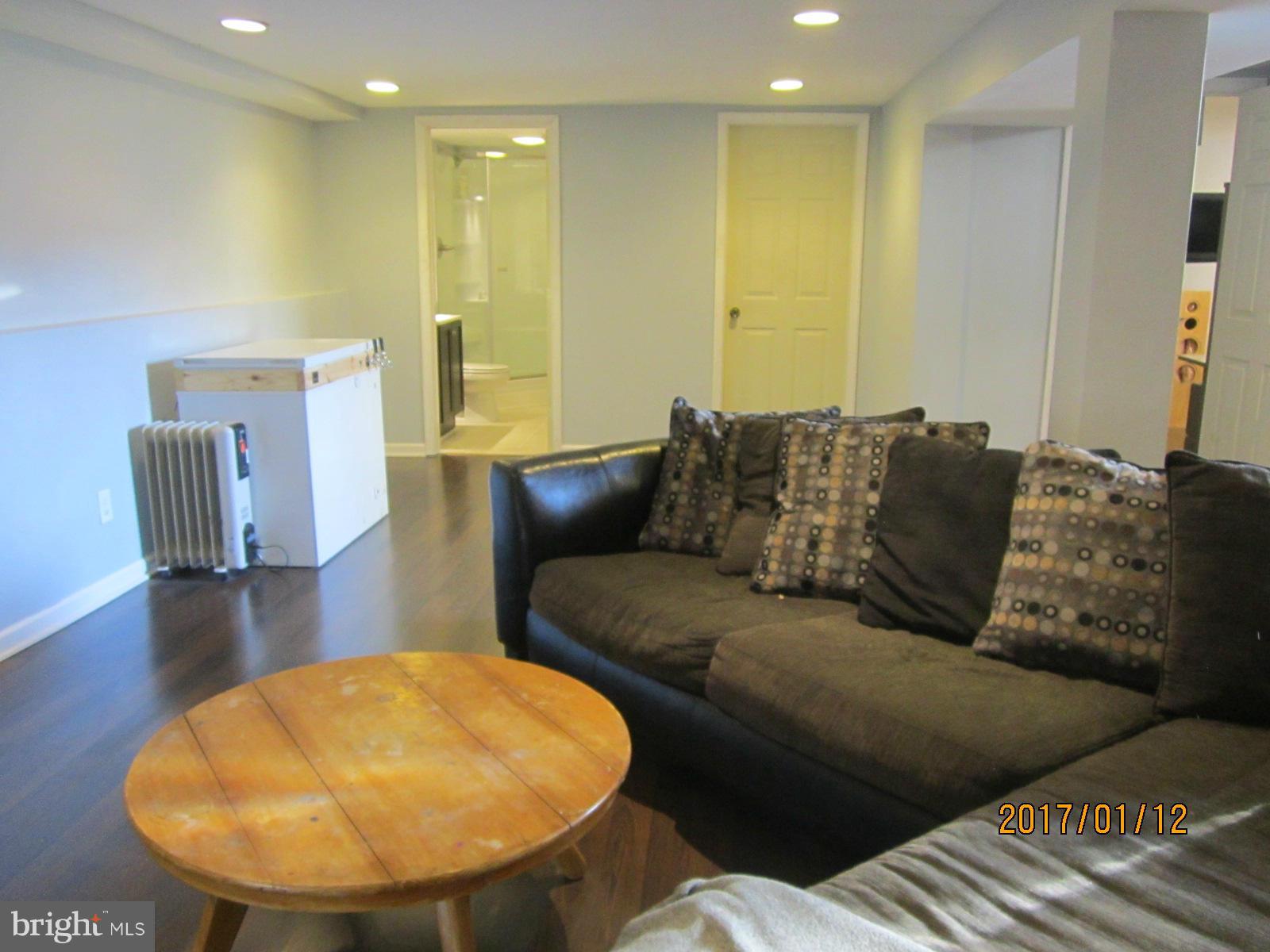 6304 Magdolena Road Baltimore, MD 21237 - Photo 21 of 26 a living room with furniture and a mirror