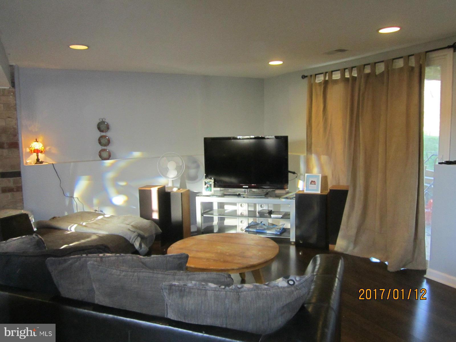6304 Magdolena Road Baltimore, MD 21237 - Photo 22 of 26 a living room with furniture and a flat screen tv