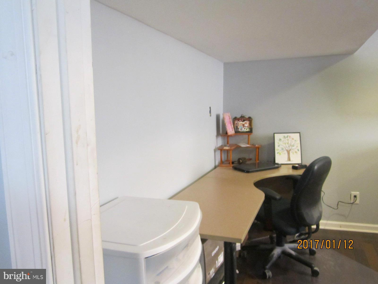 6304 Magdolena Road Baltimore, MD 21237 - Photo 25 of 26 a workspace with furniture and wooden floor
