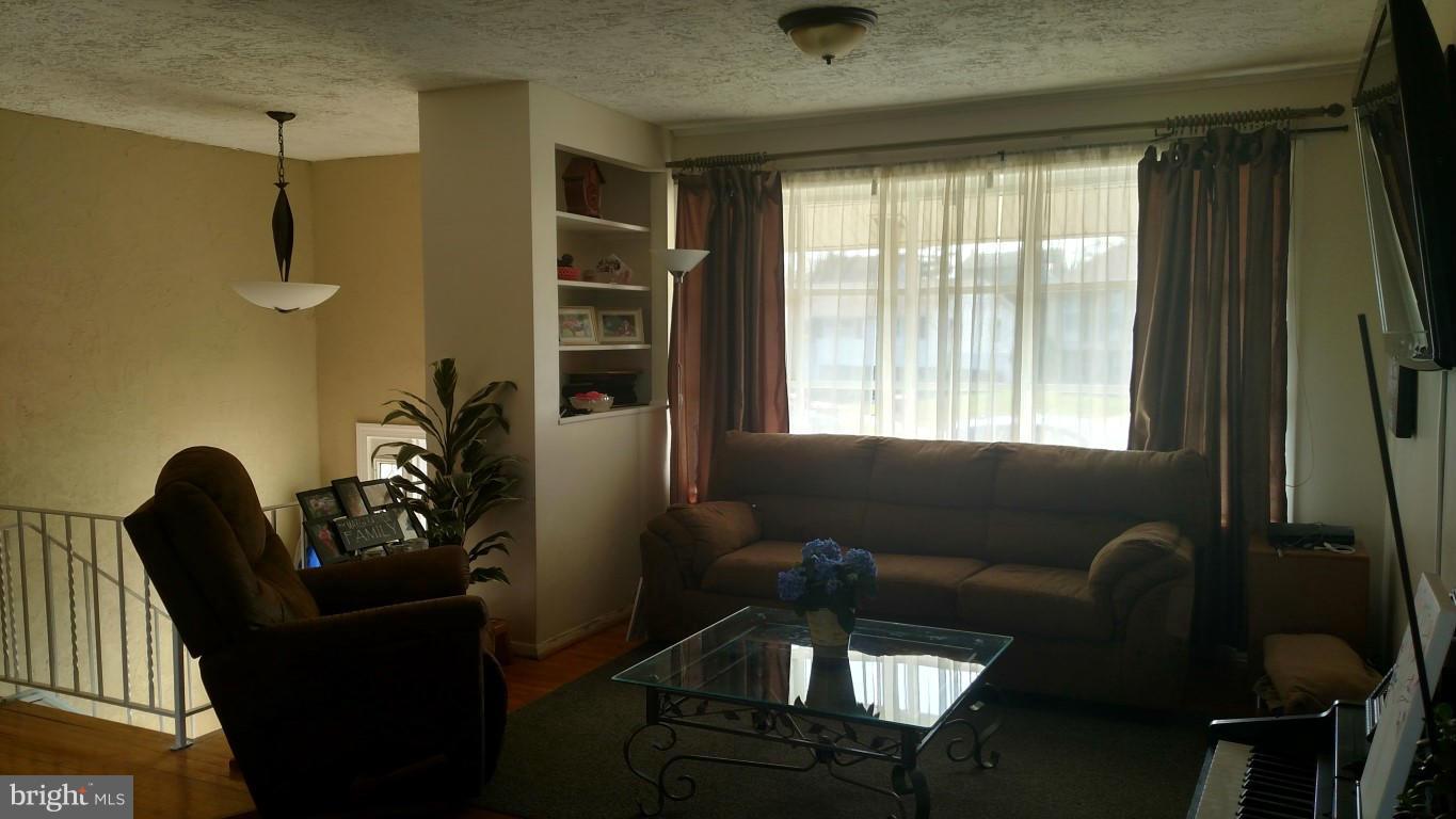 6304 Magdolena Road Baltimore, MD 21237 - Photo 7 of 26 a living room with furniture and a window