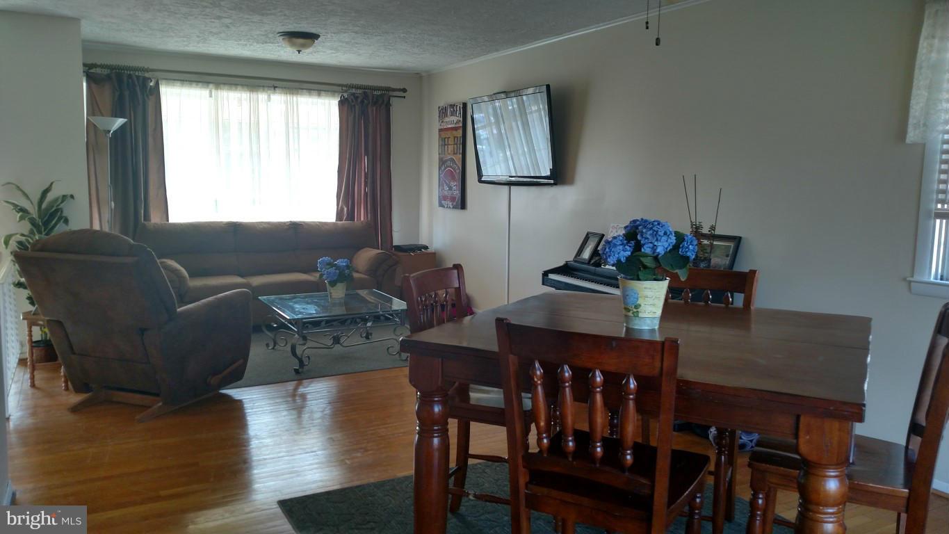 6304 Magdolena Road Baltimore, MD 21237 - Photo 8 of 26 a dining room with furniture and wooden floor