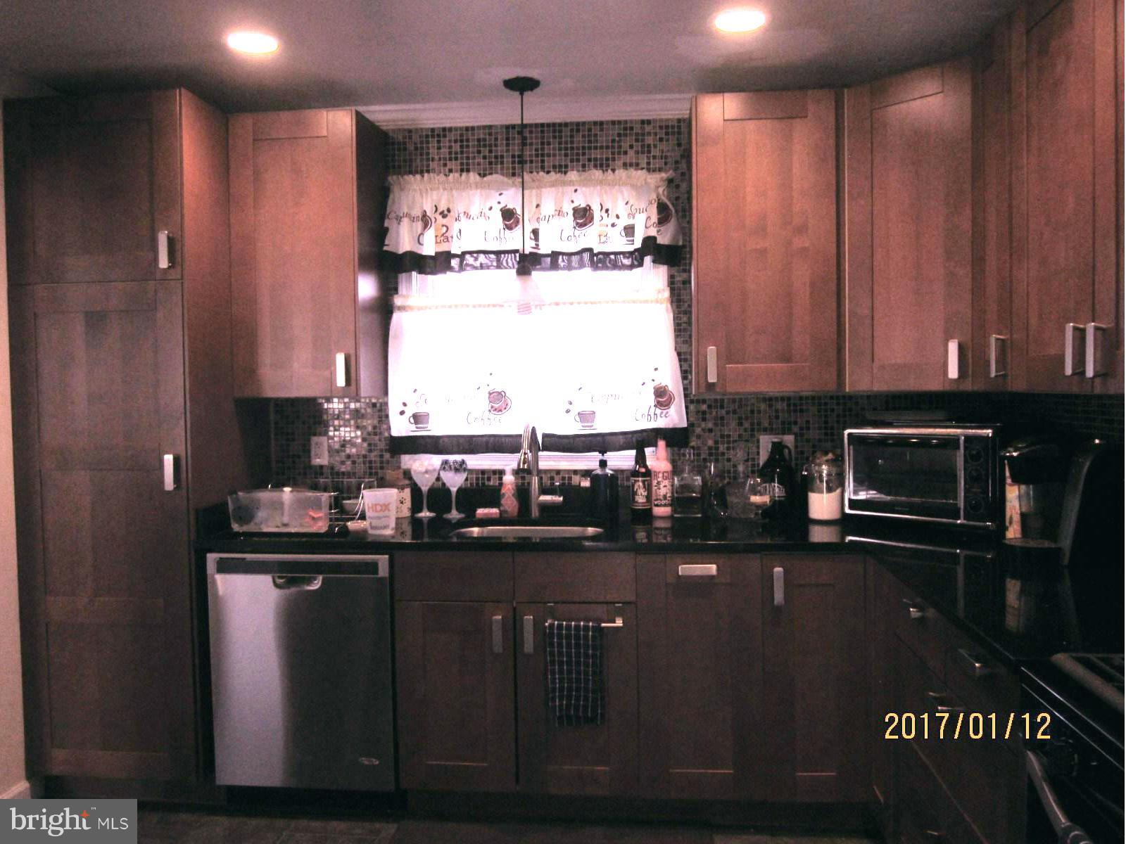 6304 Magdolena Road Baltimore, MD 21237 - Photo 10 of 26 a kitchen with a sink and cabinets