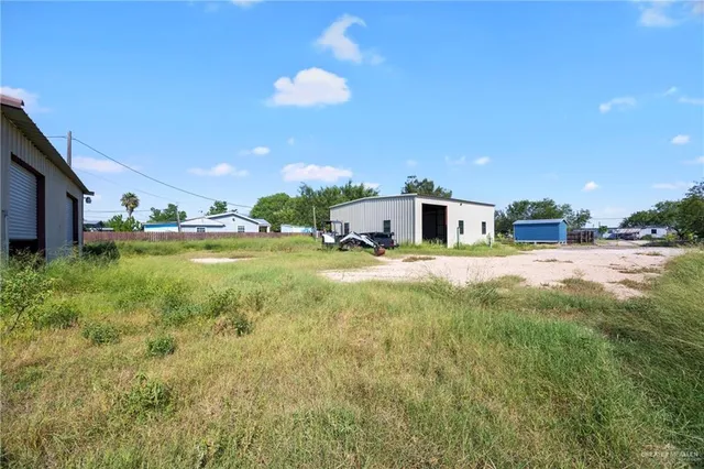 a view of a house with a yard and swimming pool