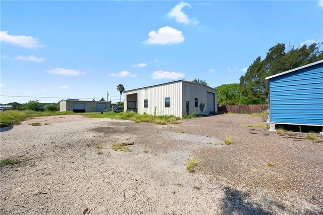 a view of a house with a backyard