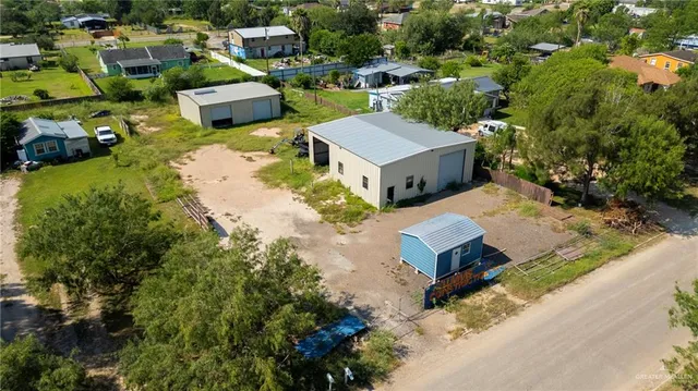 an aerial view of a house with yard swimming pool and outdoor seating