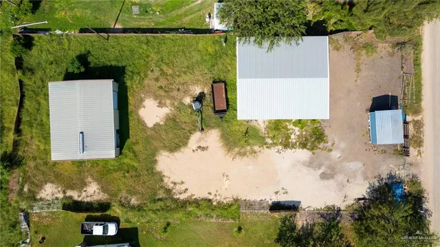 an aerial view of a house with a yard