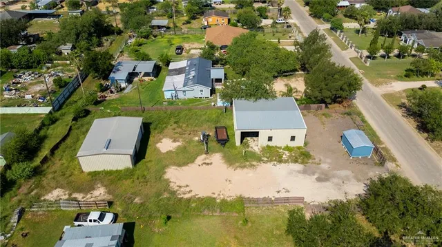 an aerial view of residential houses with outdoor space and swimming pool