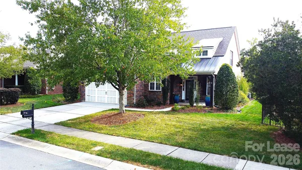 a view of a house with a yard and tree s