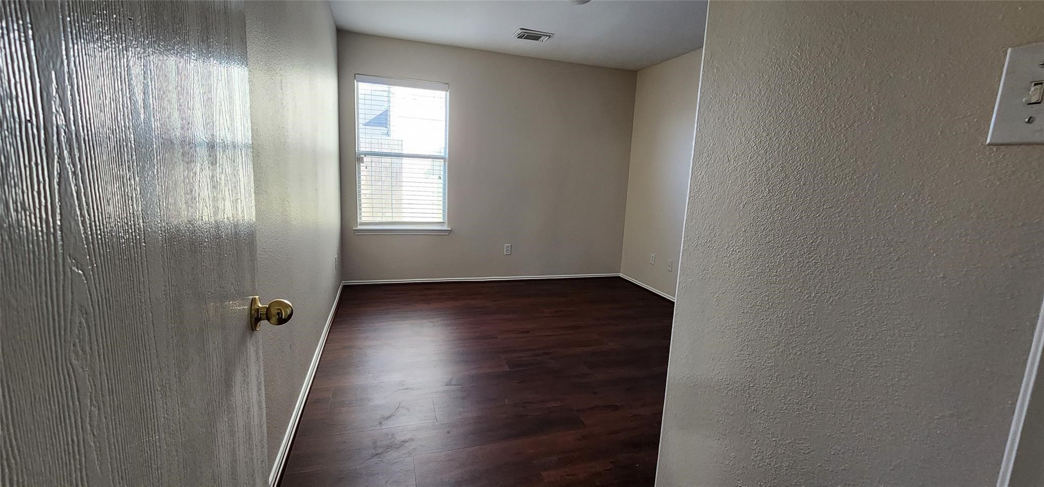 315 Sunset Colony Drive Rosharon, TX 77583 - Photo 16 of 20 an empty room with wooden floor and a window