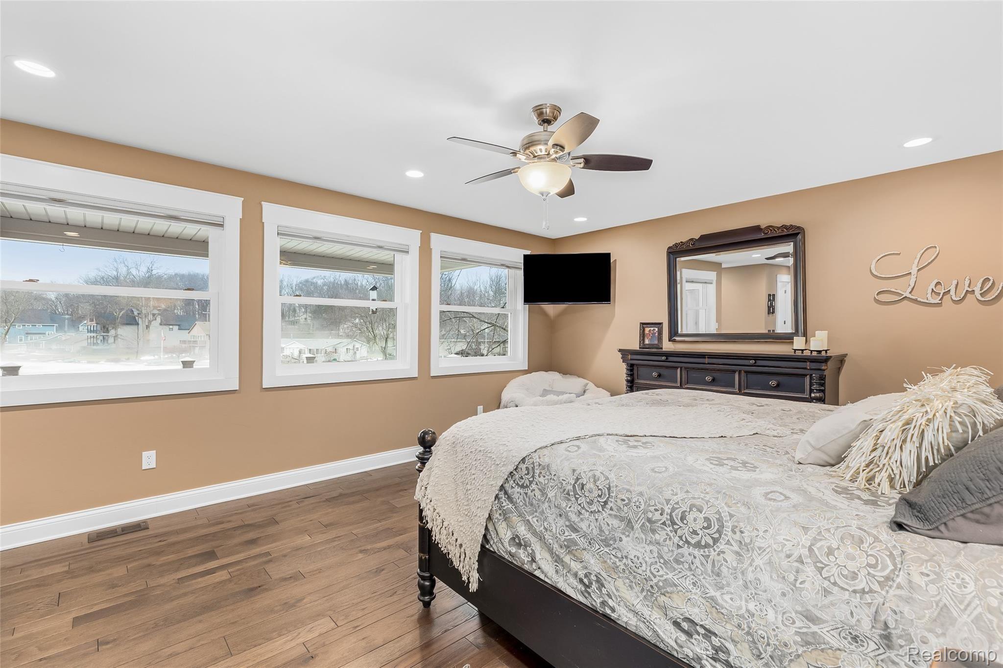 10136 Buhl Road Pinckney, MI 48169 - Photo 21 of 54 Second floor master bedroom with large windows overlooking the lake