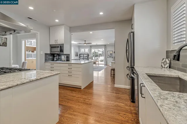 a kitchen with stainless steel appliances granite countertop a stove and a sink