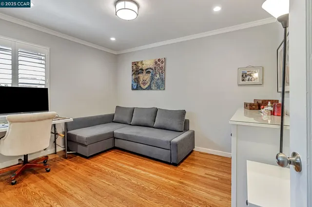 a living room with furniture and wall painting
