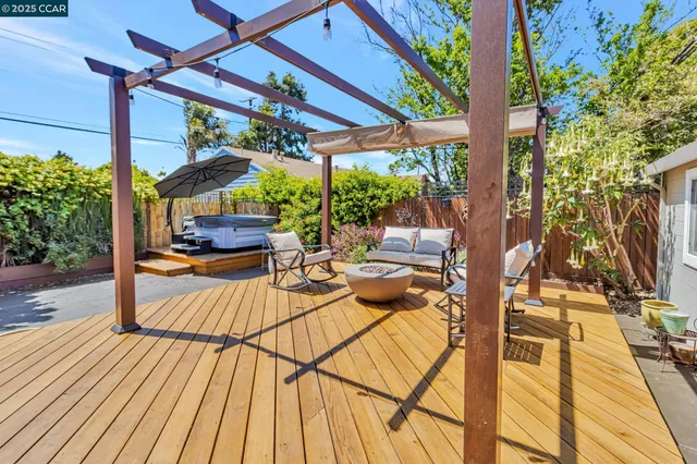 a view of a sitting area with furniture and umbrella