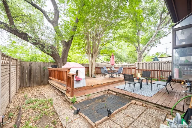 a view of a backyard with sitting area