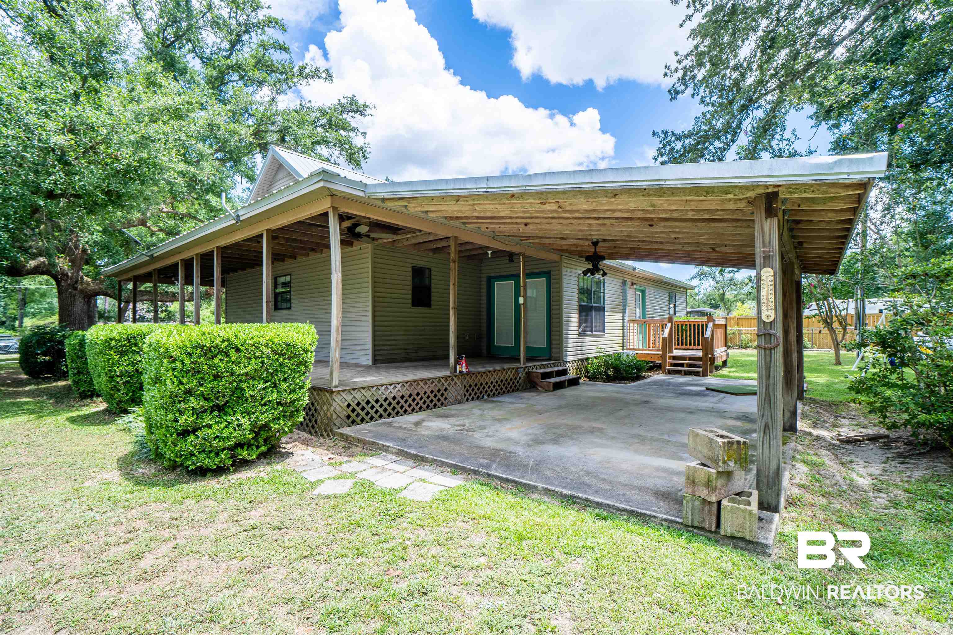 Rear view of house with a patio area, a yard, and ceiling fan