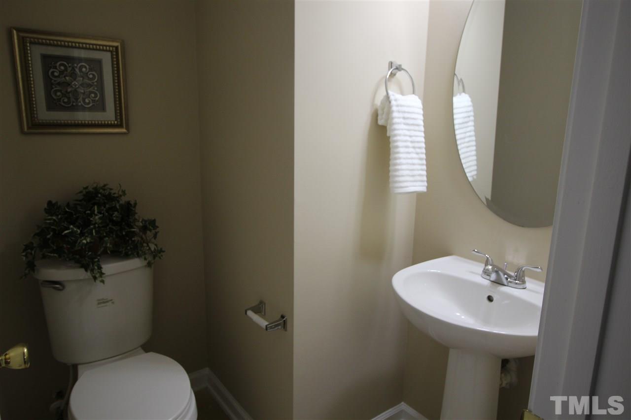 2411 Quarry Ridge Lane Raleigh, NC 27610 - Photo 12 of 22 a bathroom with a toilet sink and mirror