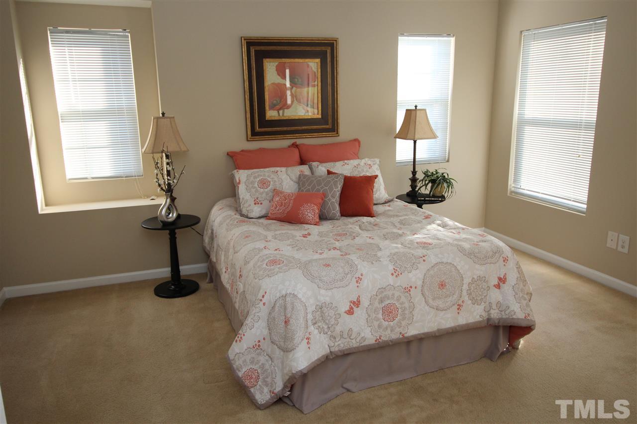 2411 Quarry Ridge Lane Raleigh, NC 27610 - Photo 13 of 22 a large bed sitting in a bedroom next to a window