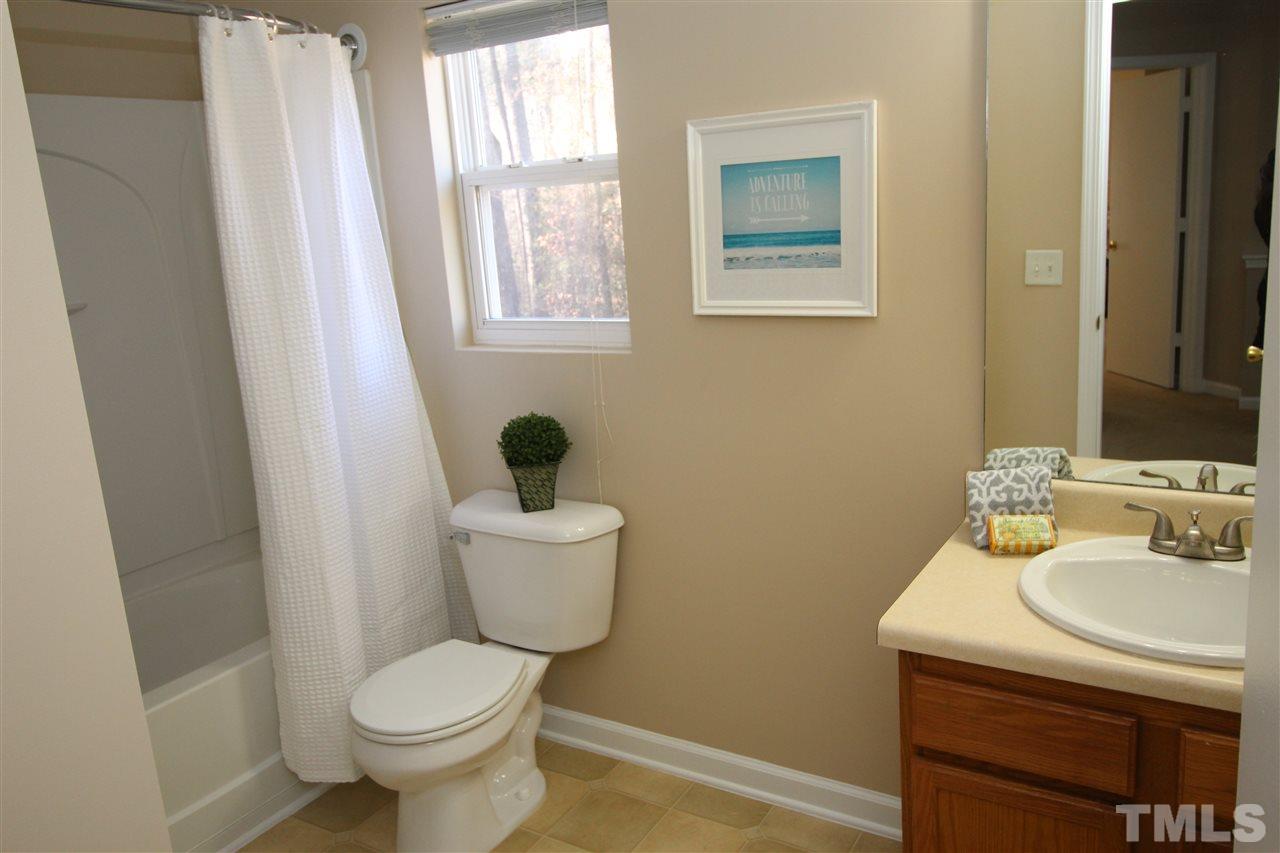 2411 Quarry Ridge Lane Raleigh, NC 27610 - Photo 19 of 22 a bathroom with a sink toilet and a mirror