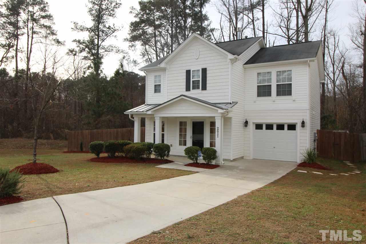 2411 Quarry Ridge Lane Raleigh, NC 27610 - Photo 21 of 22 a view of a white house with a yard and sitting area