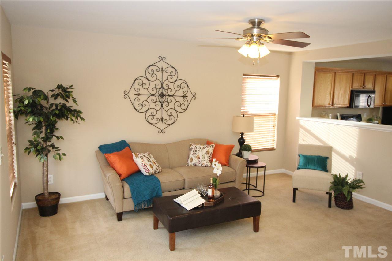 2411 Quarry Ridge Lane Raleigh, NC 27610 - Photo 5 of 22 a living room with furniture and a chandelier