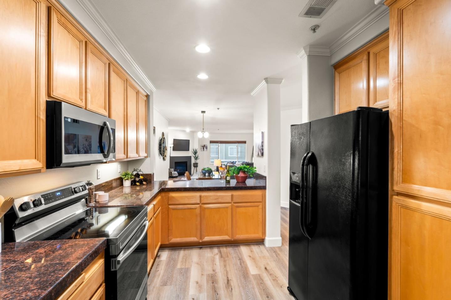 852 Diablo Avenue, Unit 104 Novato, CA 94947 - Photo 13 of 23 a kitchen with stainless steel appliances a refrigerator a stove a sink and a microwave