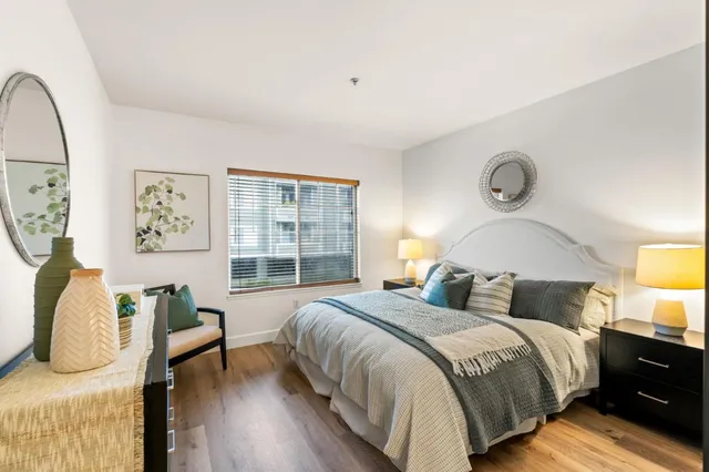 a bedroom with bed and wooden floor
