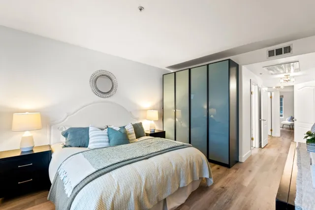 a bedroom with a bed and a lamp