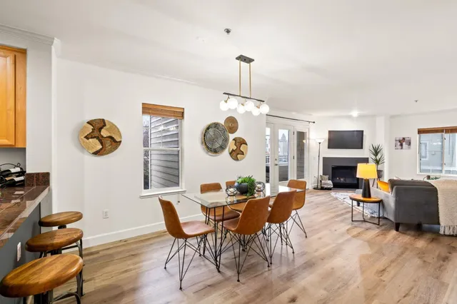 a view of a dining room with furniture and chandelier