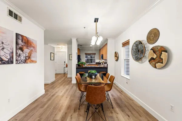 a view of a dining room with furniture and wooden floor