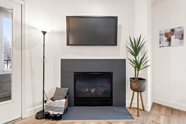 a living room with furniture a fireplace and a flat screen tv